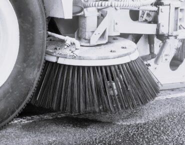 Parking lot cleaning with power sweeper