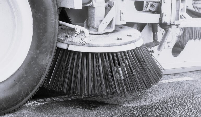 Parking lot cleaning with power sweeper